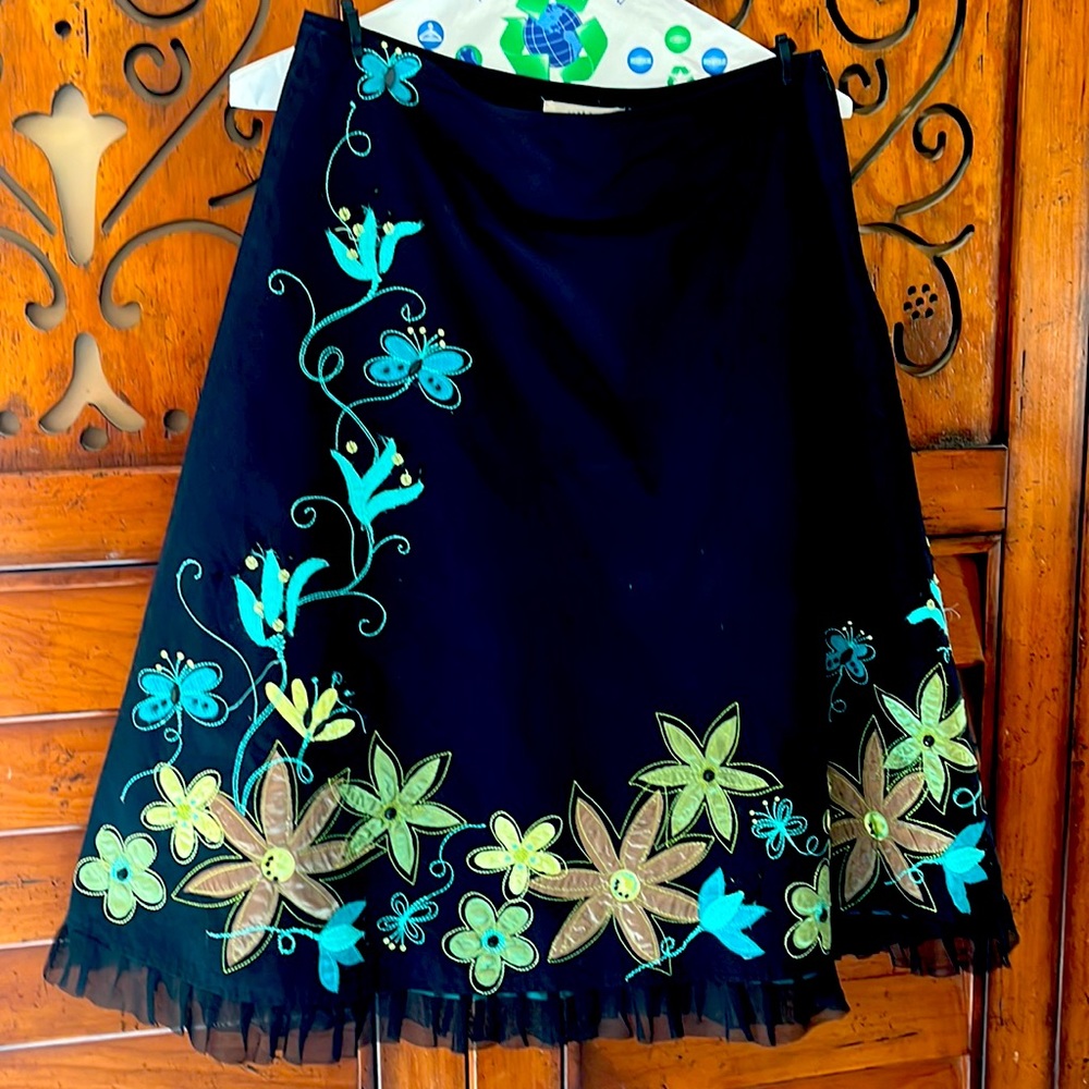Black lined dress with lace at bottom.  Silky flowers stitched on with beads
